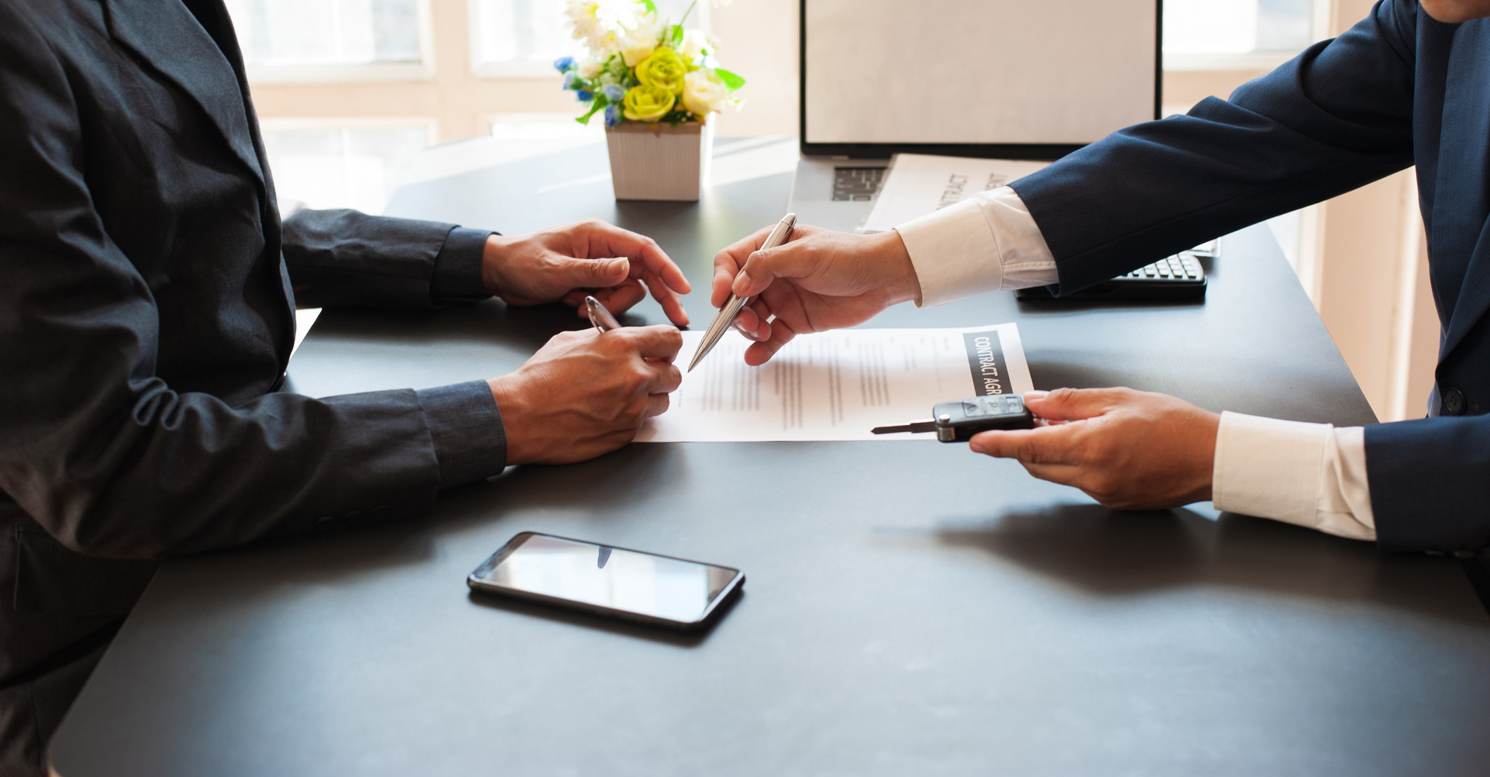 Signing car insurance document or lease paper. Concept of car lease / purchase agreement signing.